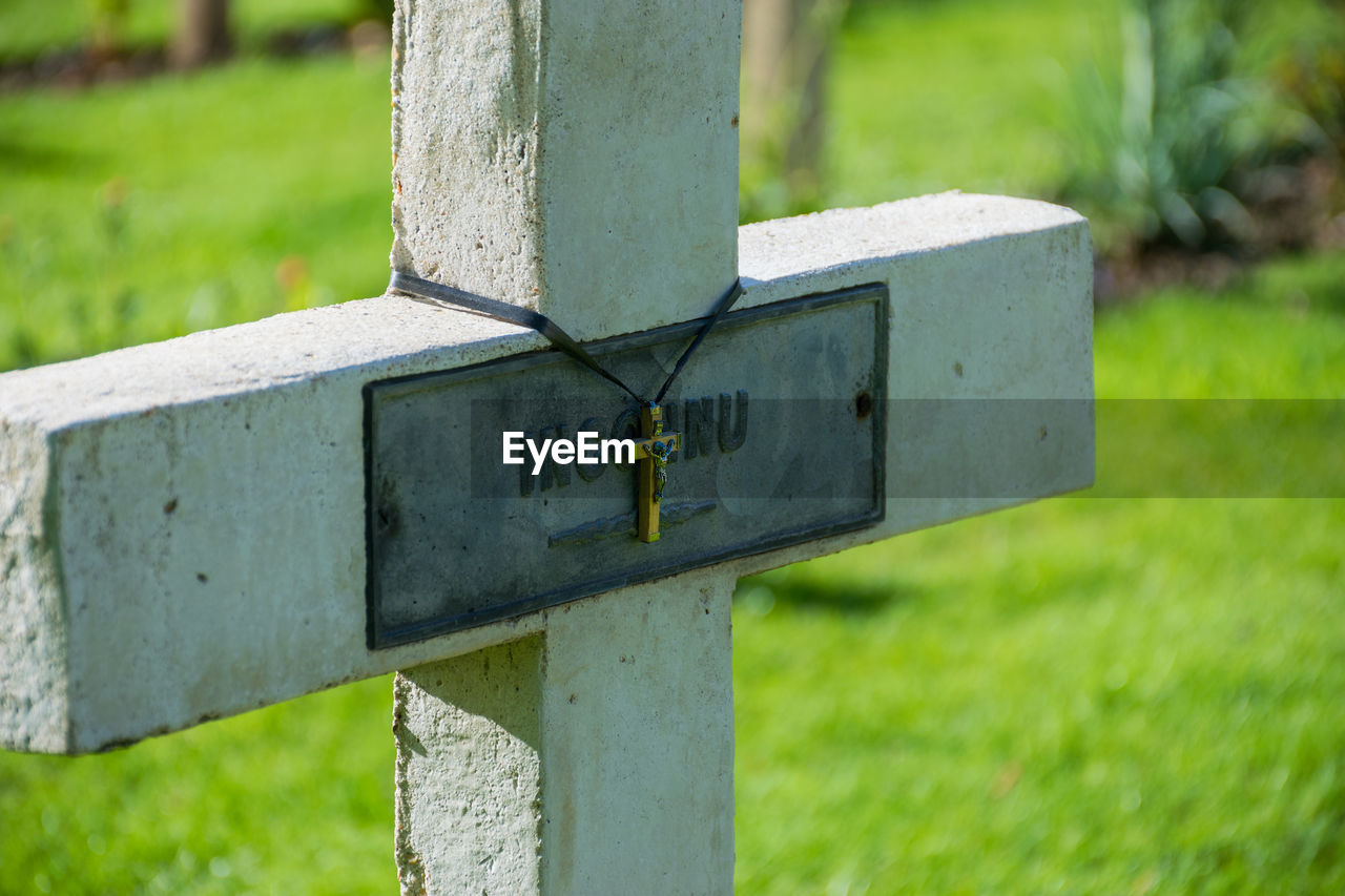 CLOSE-UP OF CROSS ON PLANT