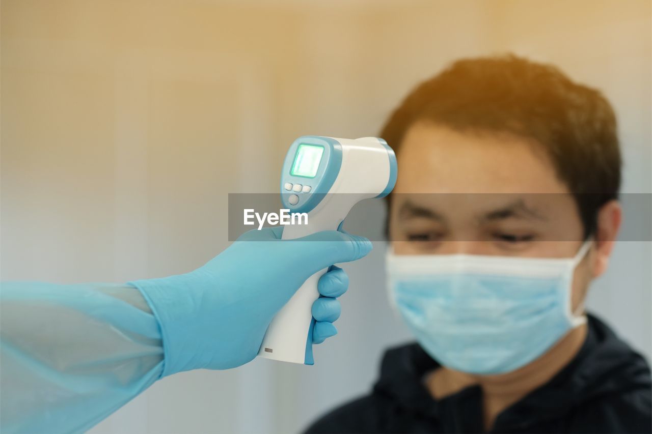 PORTRAIT OF TWO PEOPLE HOLDING CAMERA IN A ROOM