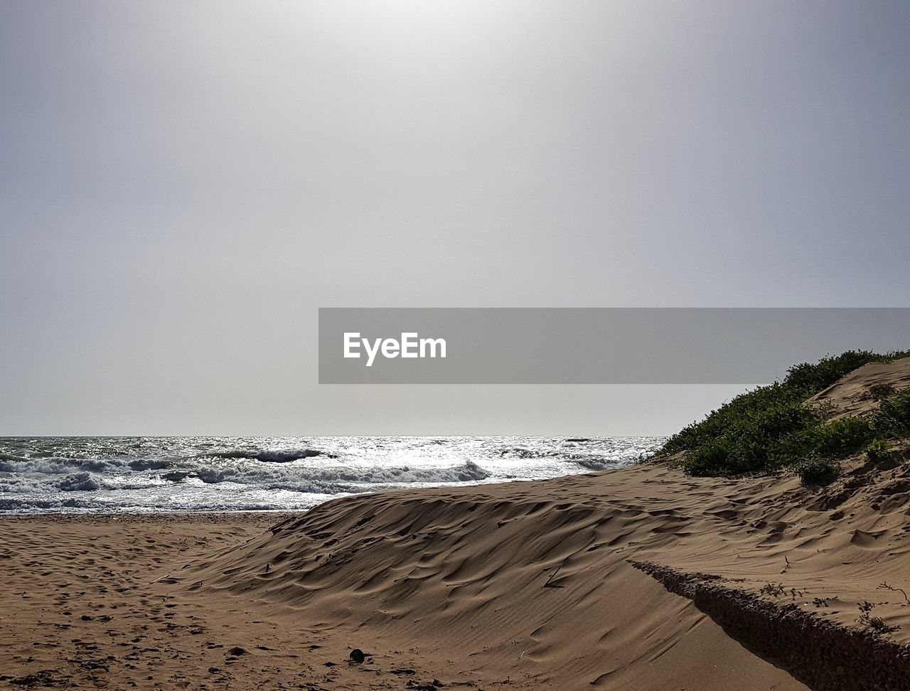 Scenic view of beach against clear sky