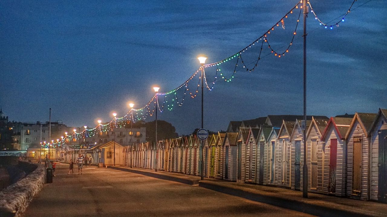 VIEW OF ILLUMINATED STREET AT NIGHT