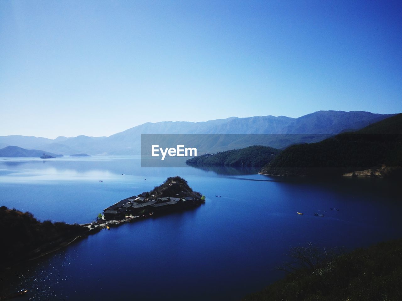 Scenic view of lake against blue sky