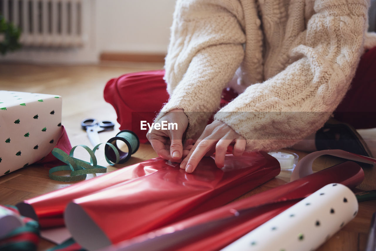 Woman's hands packing christmas presents