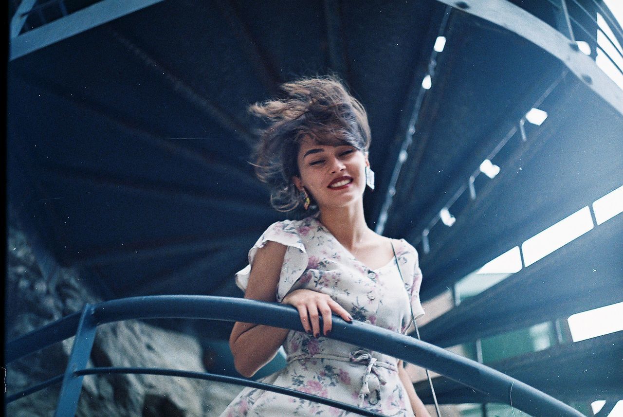 Low angle view of smiling young woman