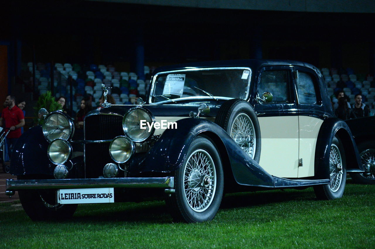 VINTAGE CAR ON FIELD DURING NIGHT