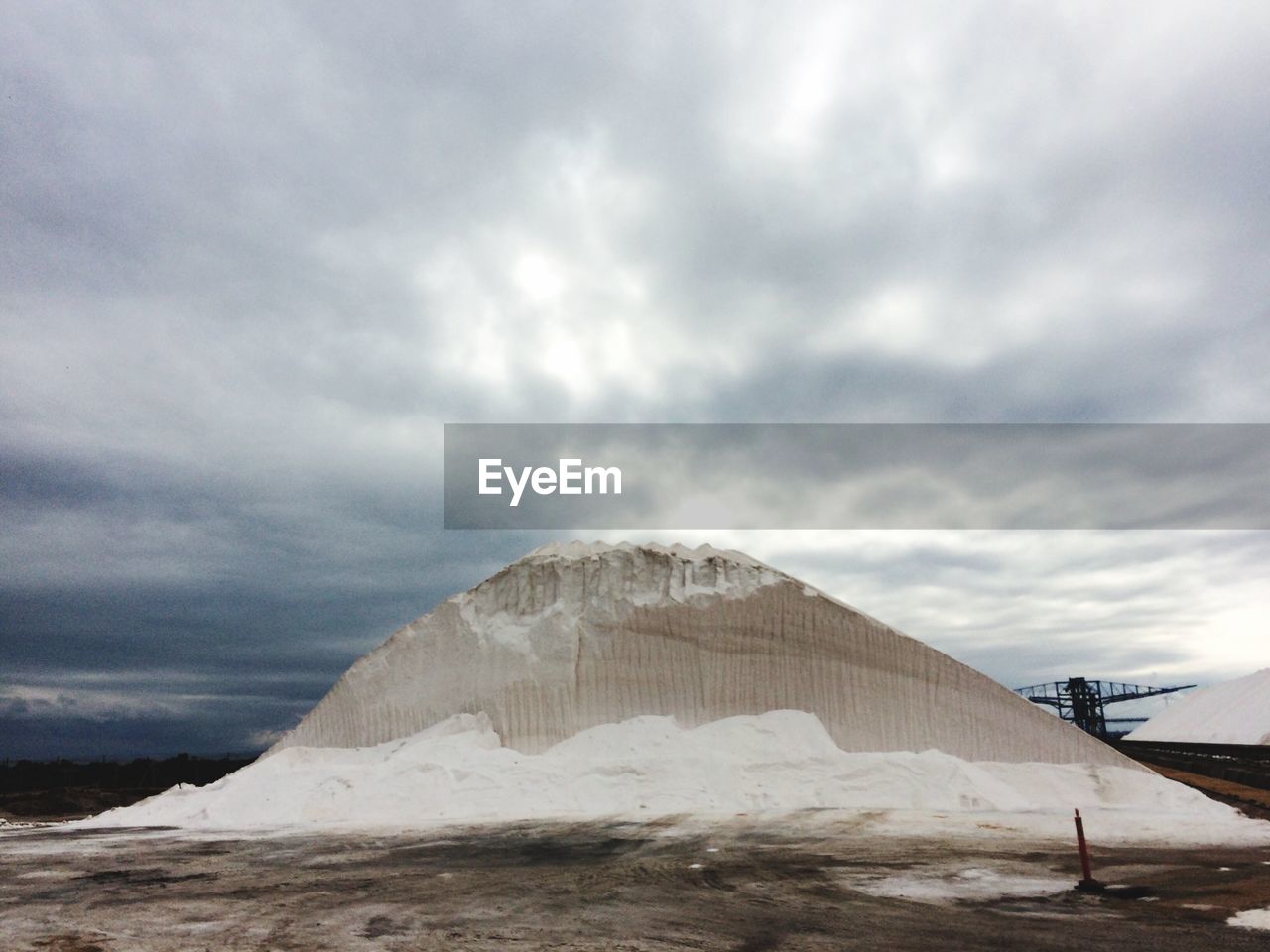 Heap of salt against cloudy sky