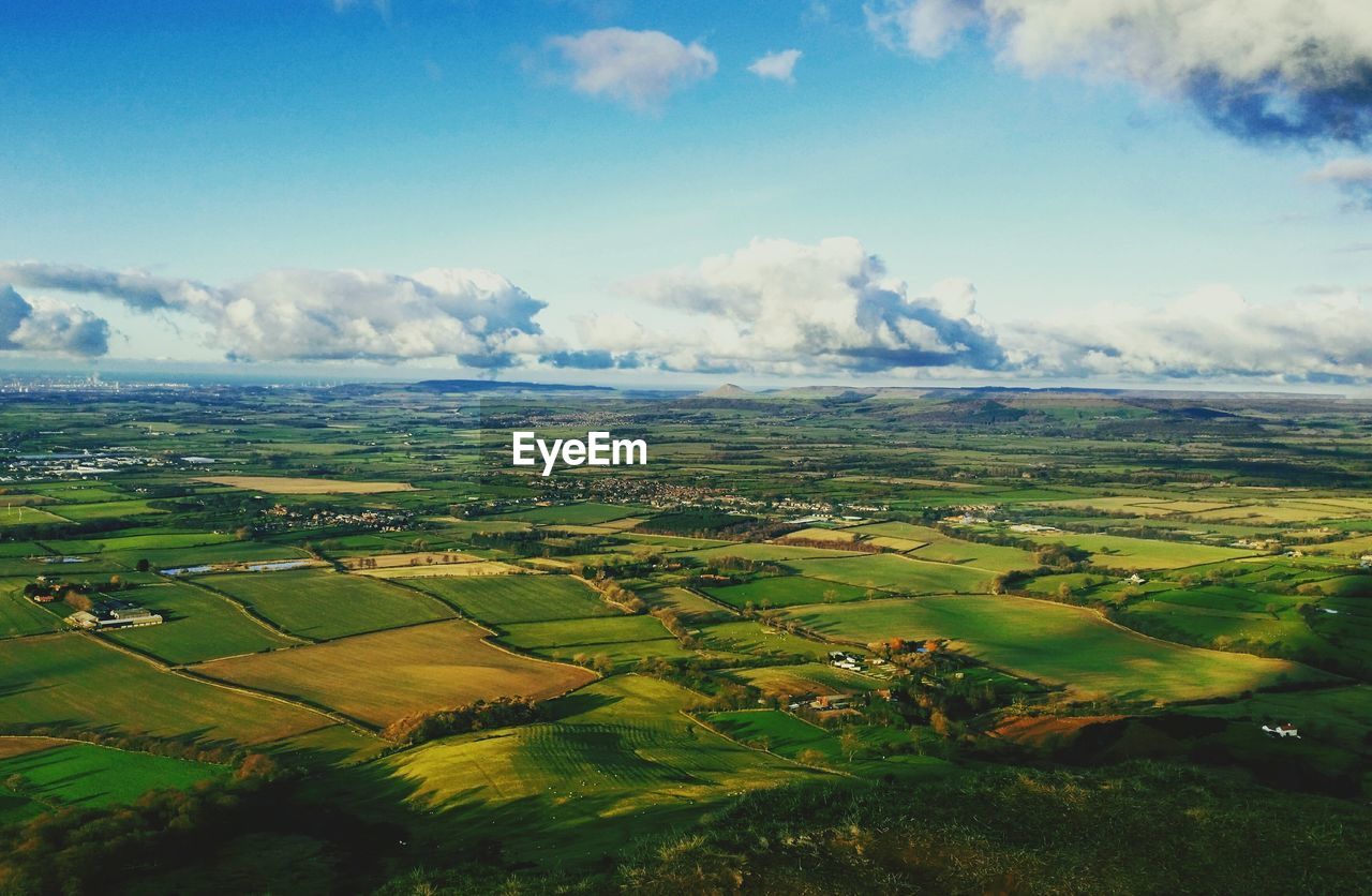 SCENIC VIEW OF GRASSY FIELD AGAINST SKY