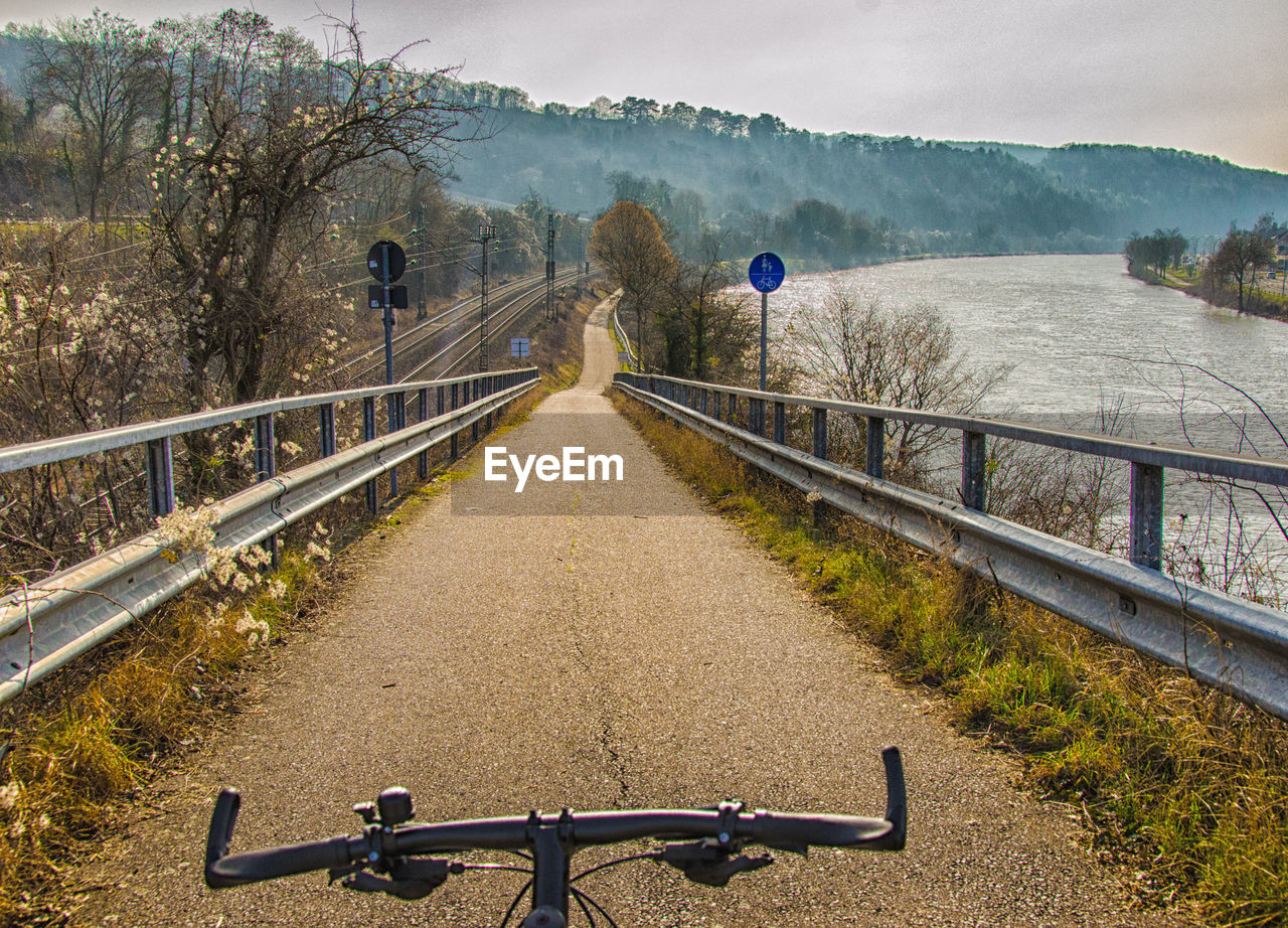 Bicycle on road by mountain against sky