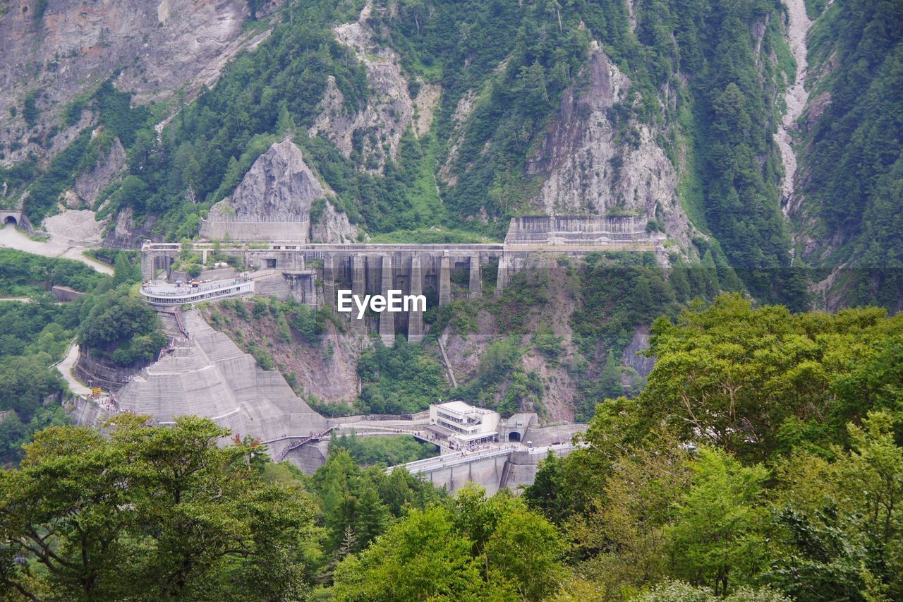 HIGH ANGLE VIEW OF BRIDGE OVER MOUNTAIN