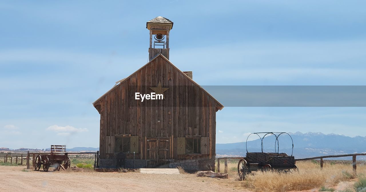 Old building on field against sky