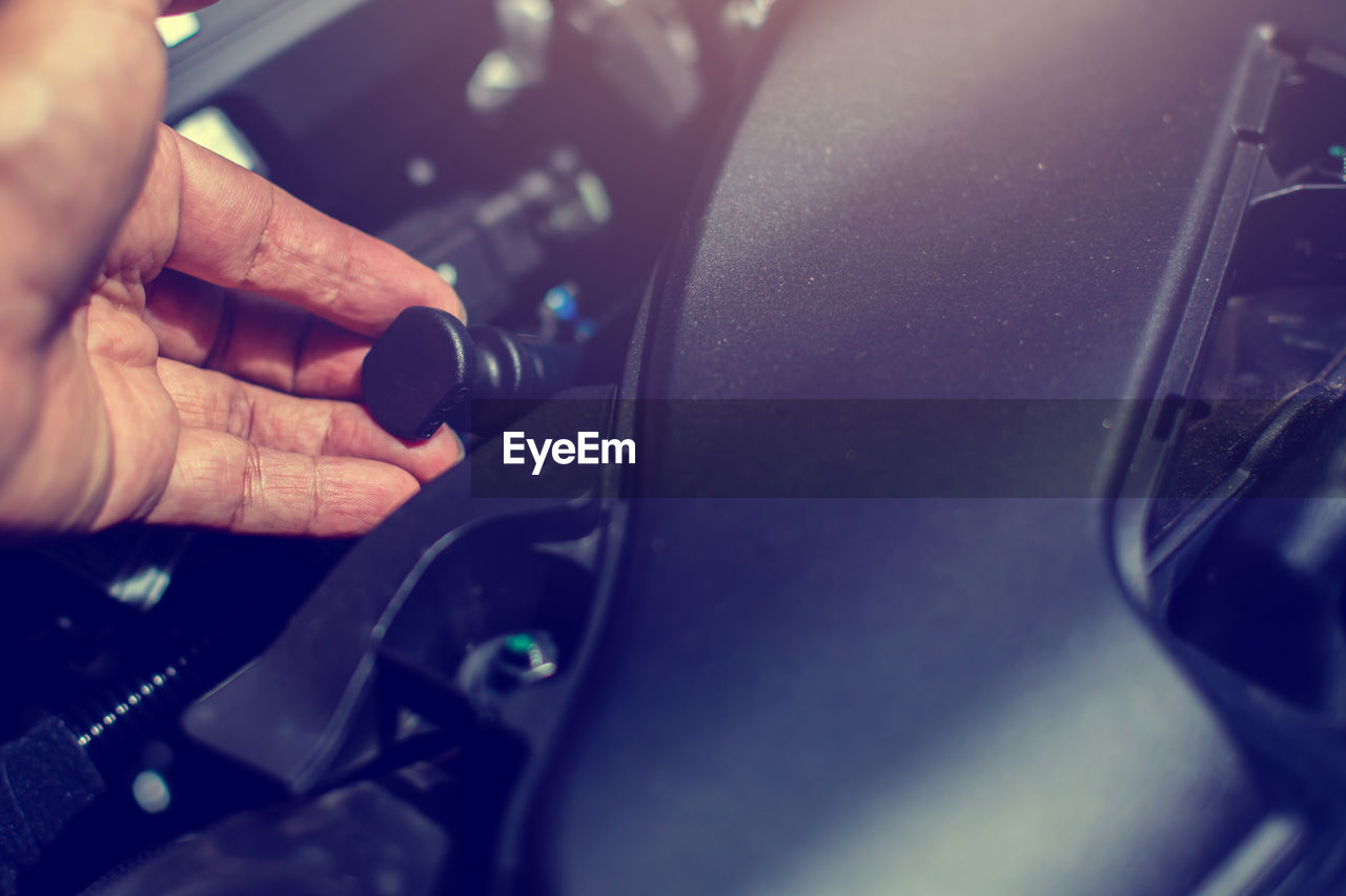 Cropped hand of man repairing car