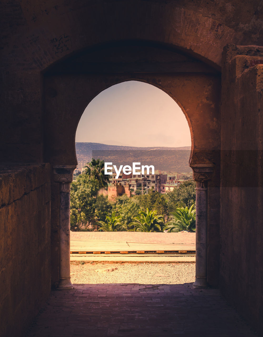 View of historic building seen through arch window