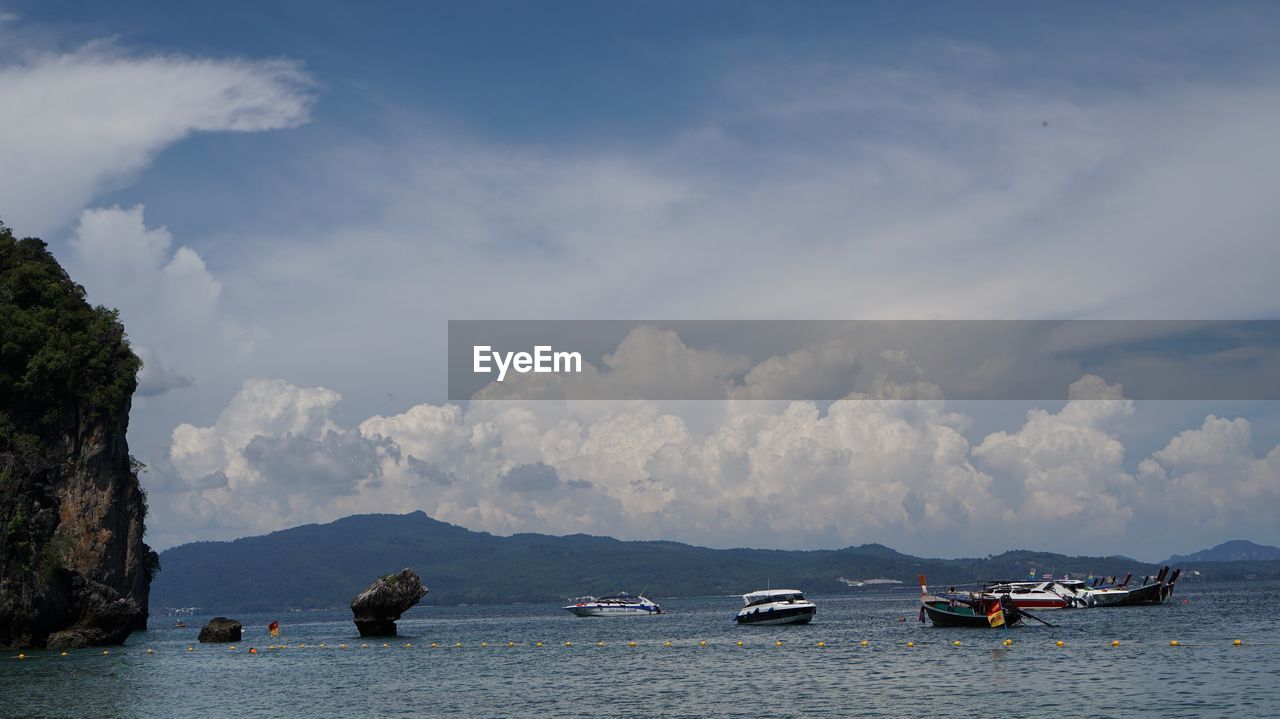 Boats in sea against sky