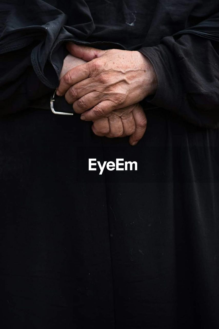 Close-up of human hand against black background