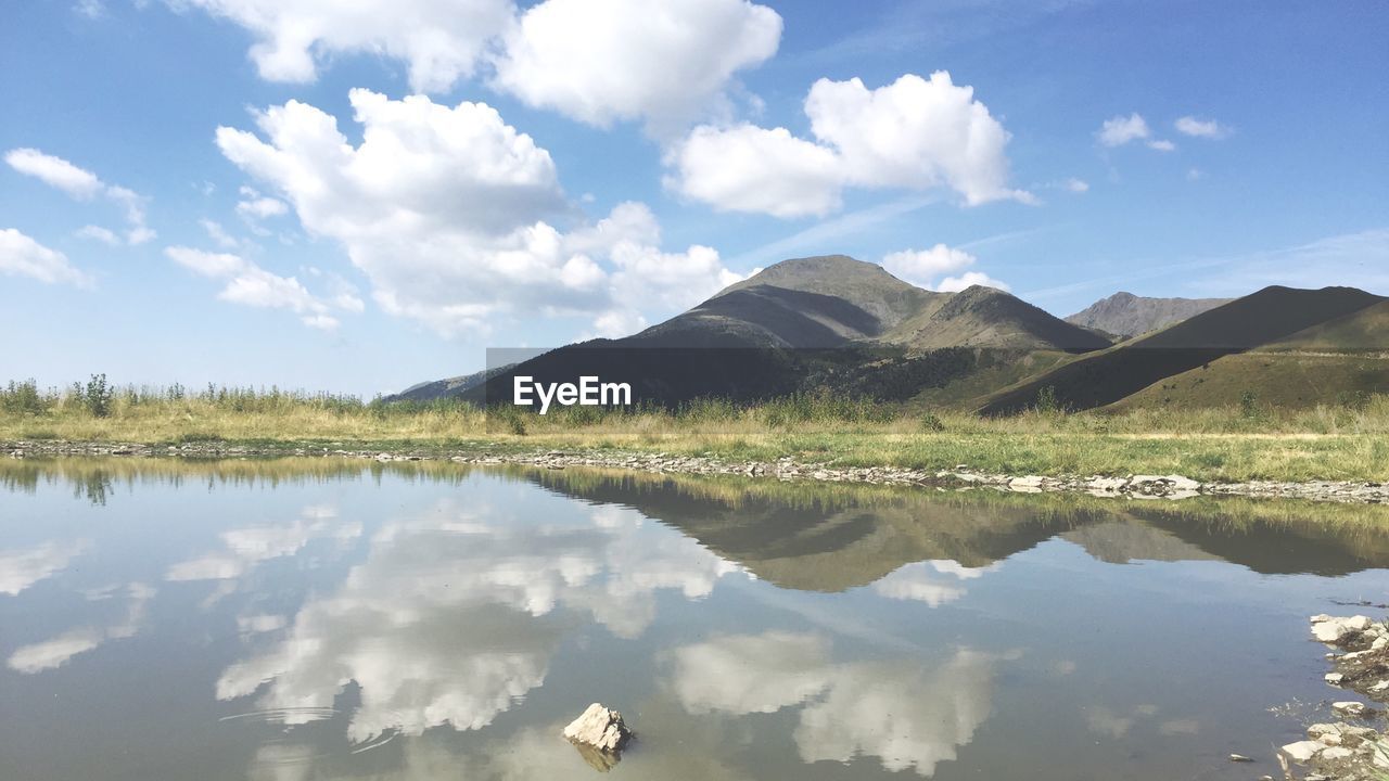 Idyllic shot of lake by mountains against sky at arinsal