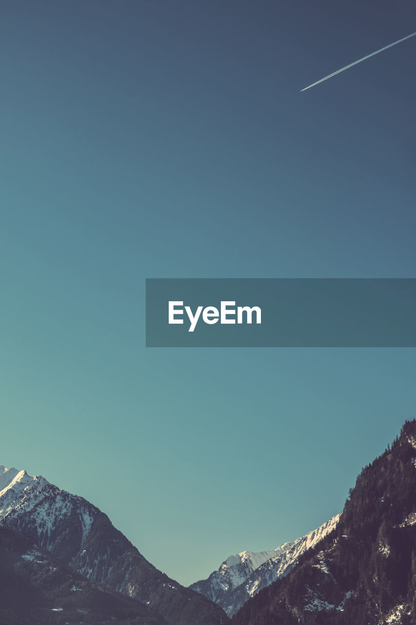 Low angle view of mountain against clear blue sky