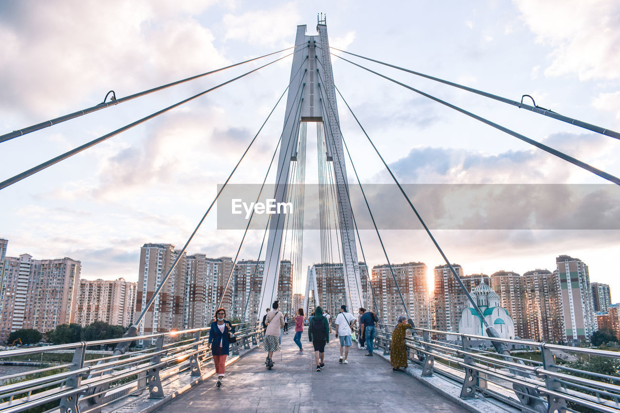 PEOPLE WALKING ON SUSPENSION BRIDGE