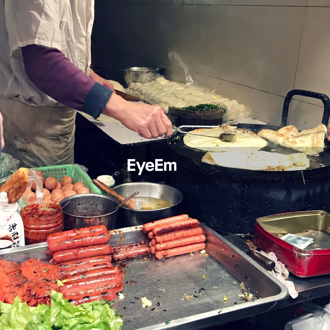 MAN WORKING ON BARBECUE