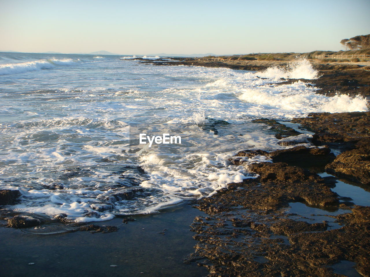 SCENIC VIEW OF FROZEN SEA AGAINST SKY AT SUNSET