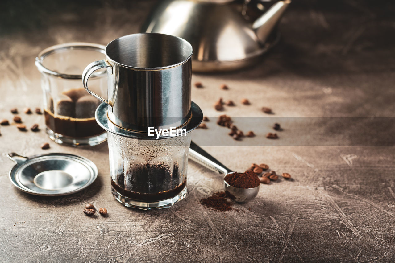 CLOSE-UP OF COFFEE CUP ON TABLE AT HOME