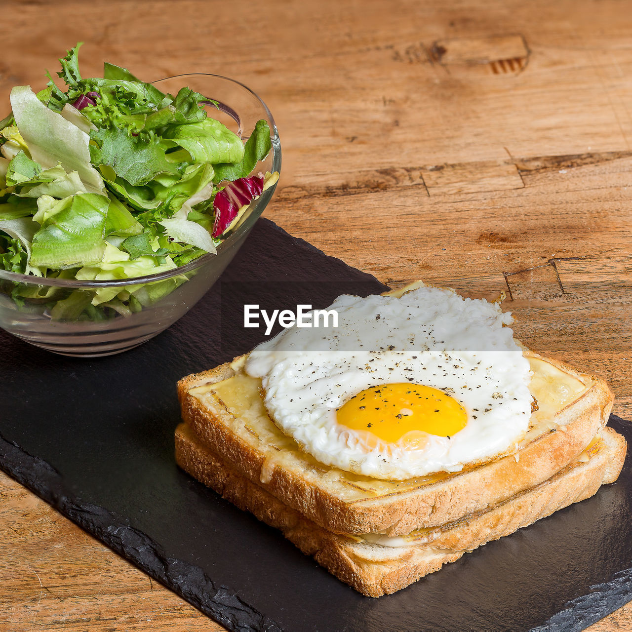 CLOSE-UP OF BREAKFAST ON CUTTING BOARD ON TABLE