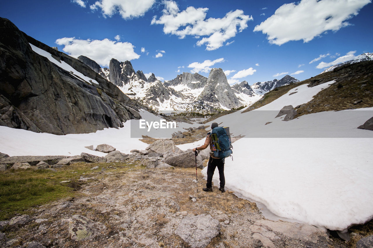 Hiker with backpack looking at view while standing at grand teton national park