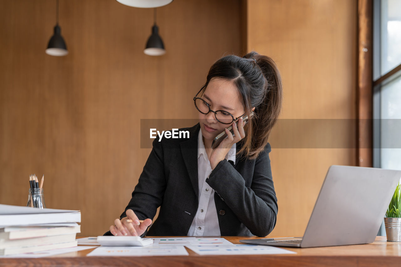 businesswoman using laptop at desk in office