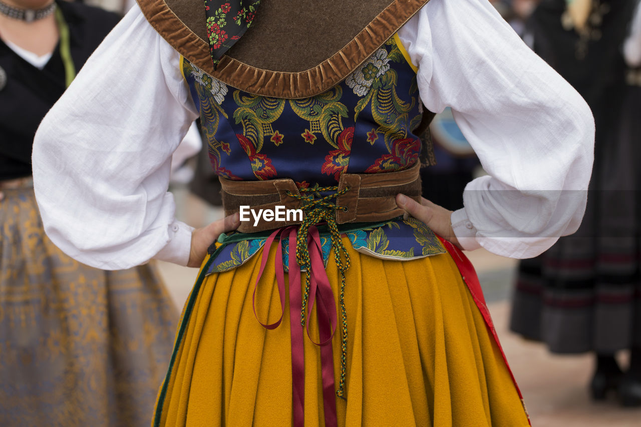 Midsection of woman wearing traditional clothing