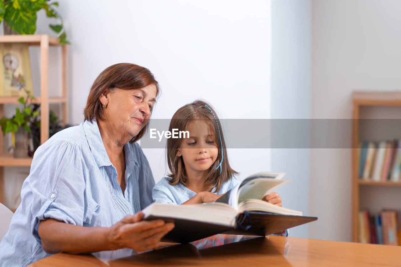 businesswoman using laptop while sitting on table