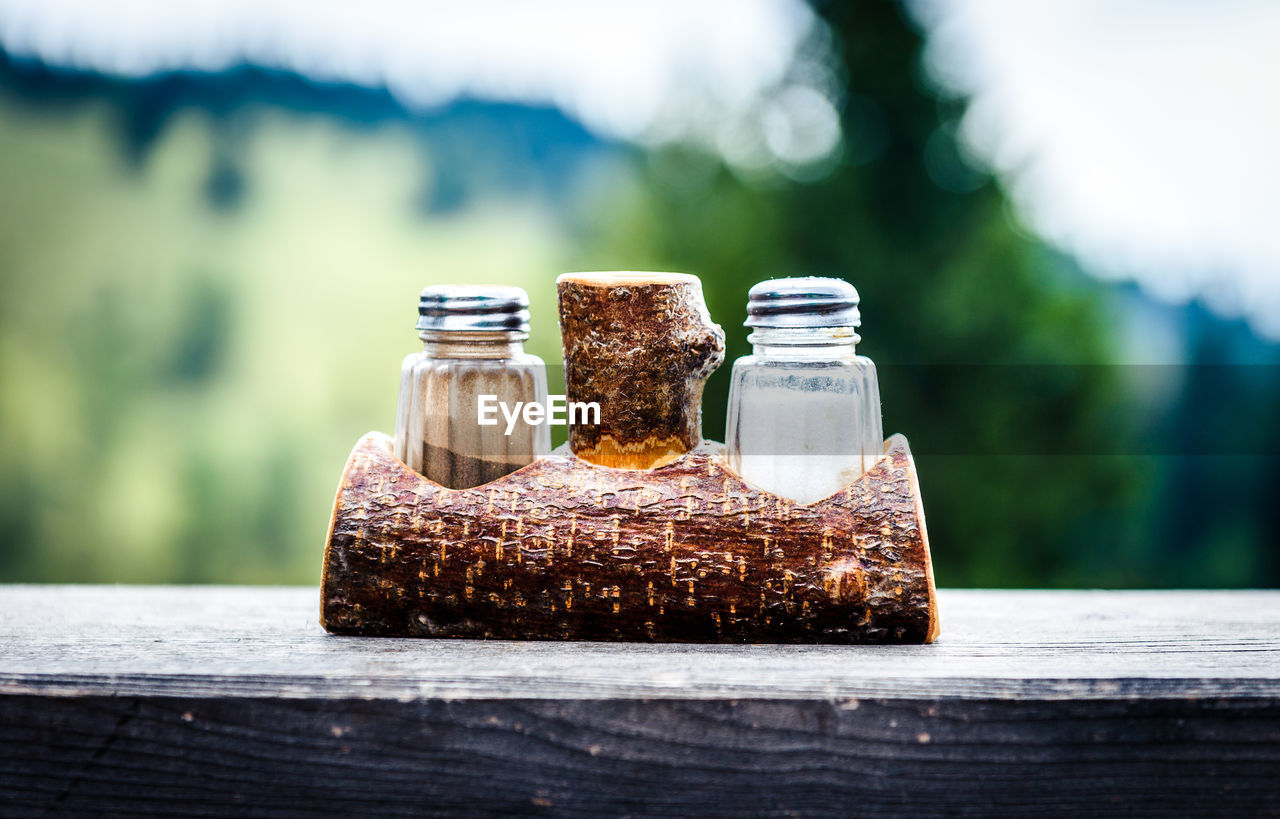 Close-up of shakers in wooden table