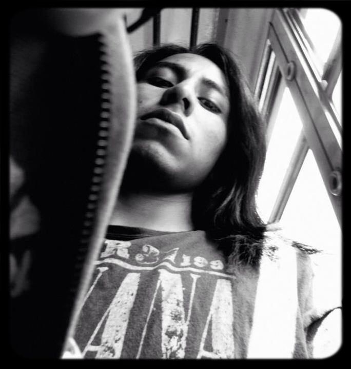 Low angle portrait of young man on seat in train