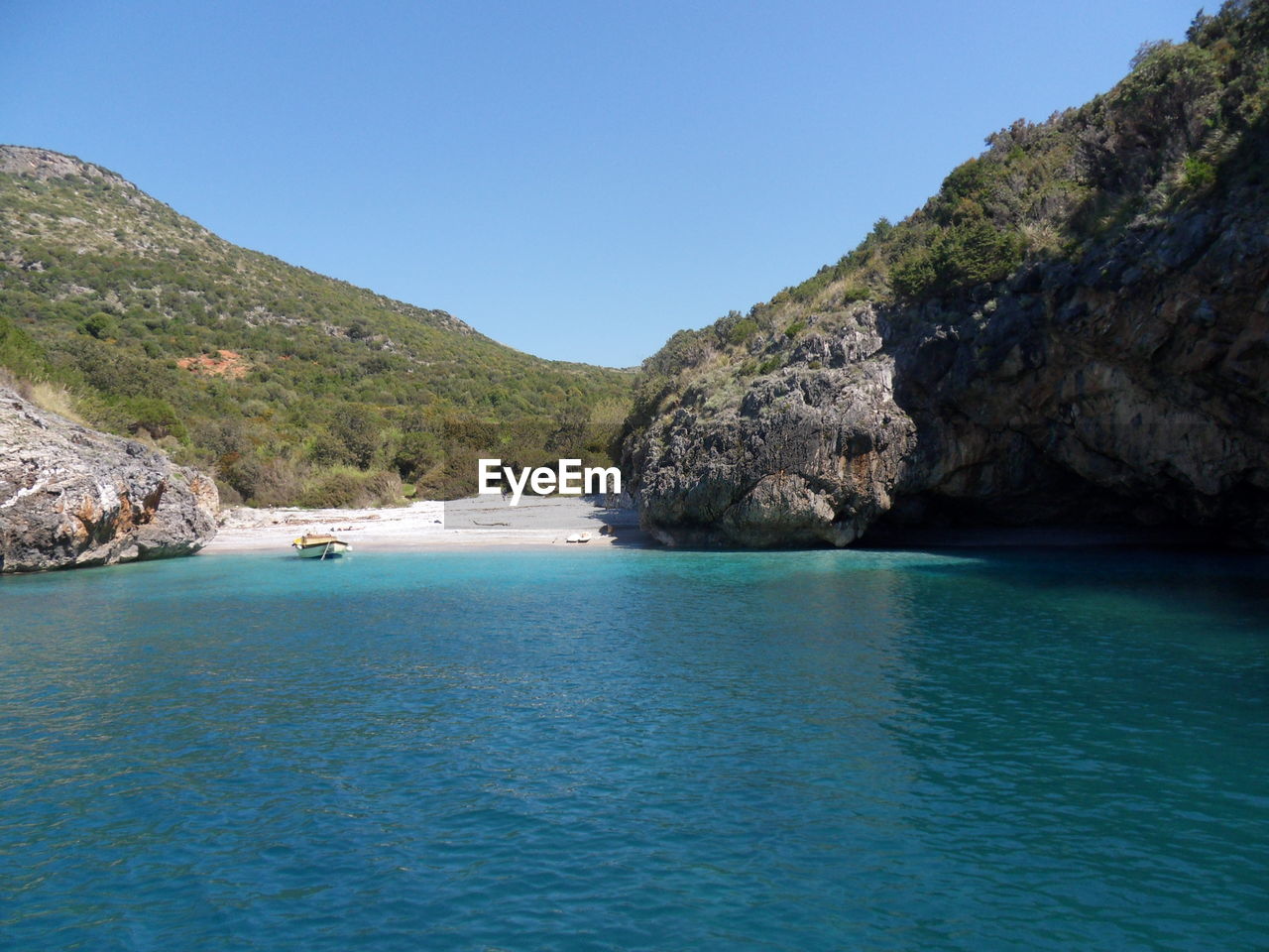 Scenic view of sea against clear blue sky