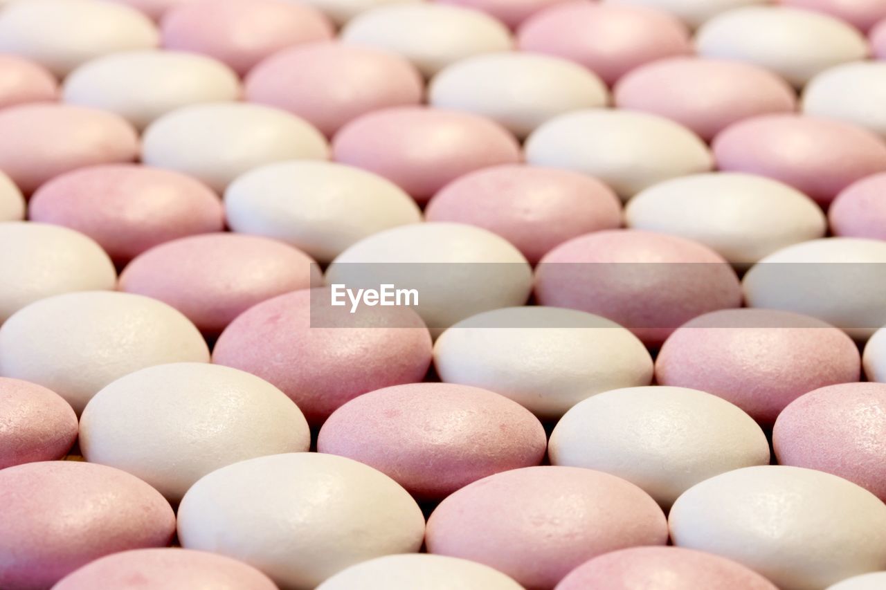 Full frame shot of pink and white macaroons