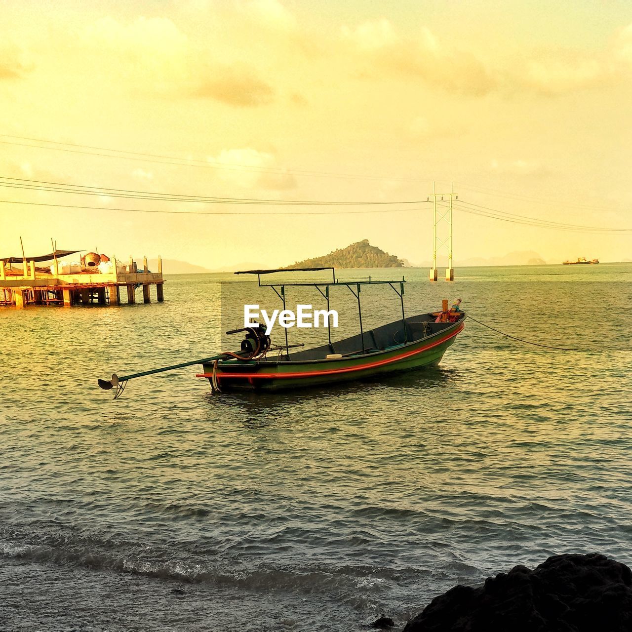 FISHING BOAT IN SEA AGAINST SKY AT SUNSET