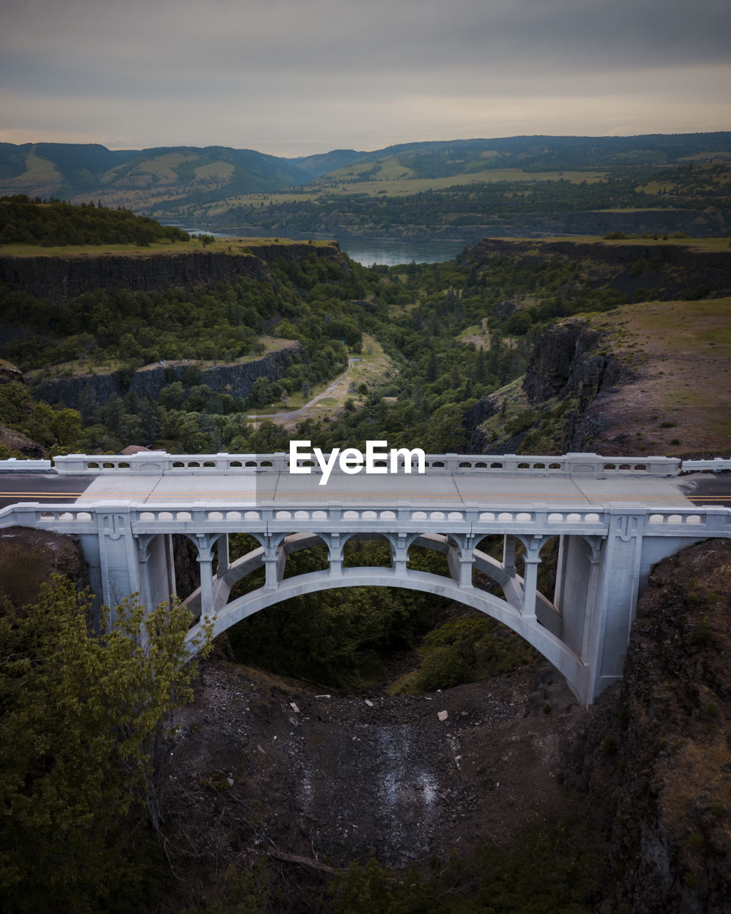 Bridge over mountain against sky