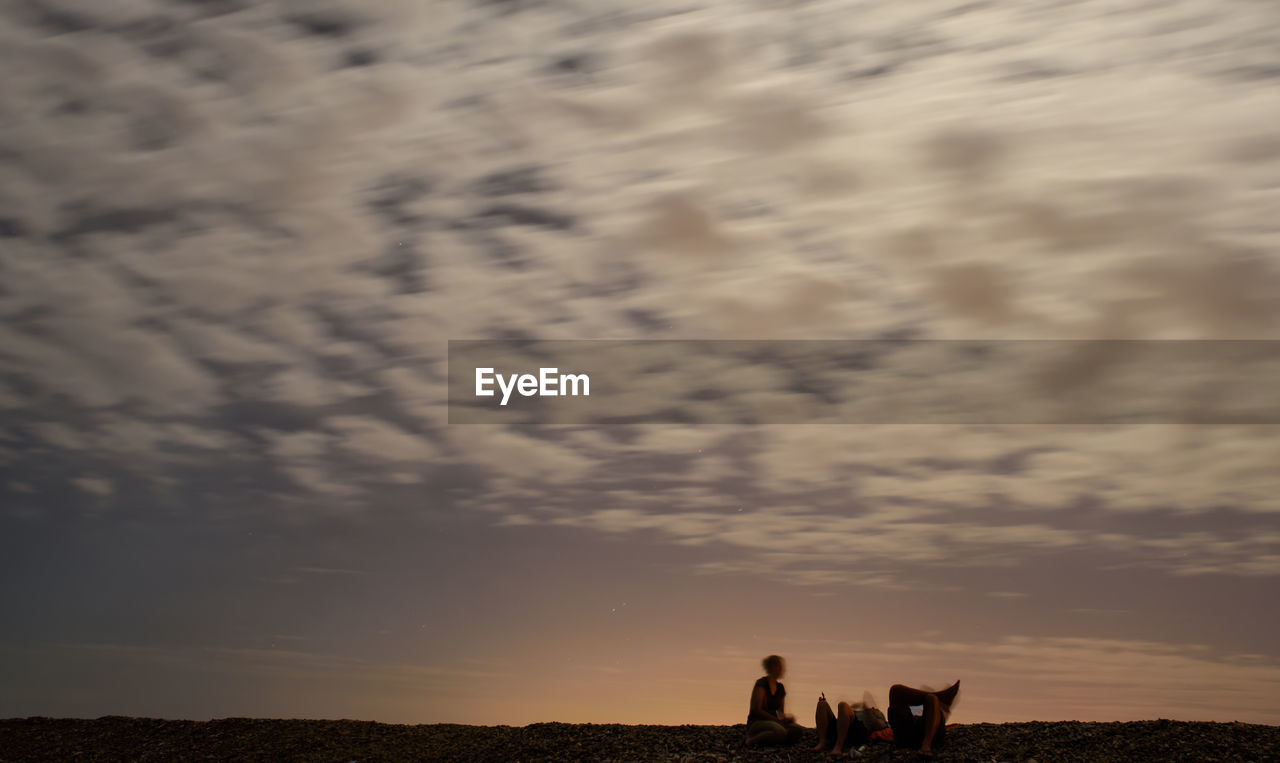 SILHOUETTE OF PEOPLE ON LANDSCAPE AGAINST SKY