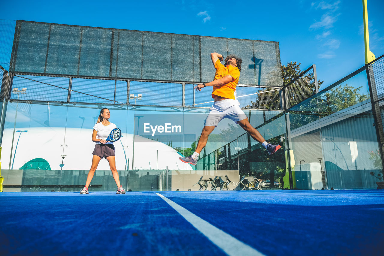 Low angle view of tennis players playing at court