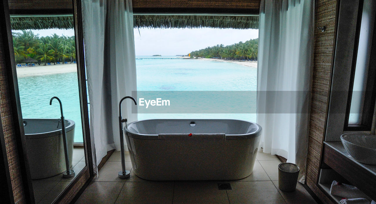 View of bathroom window overlooking sea