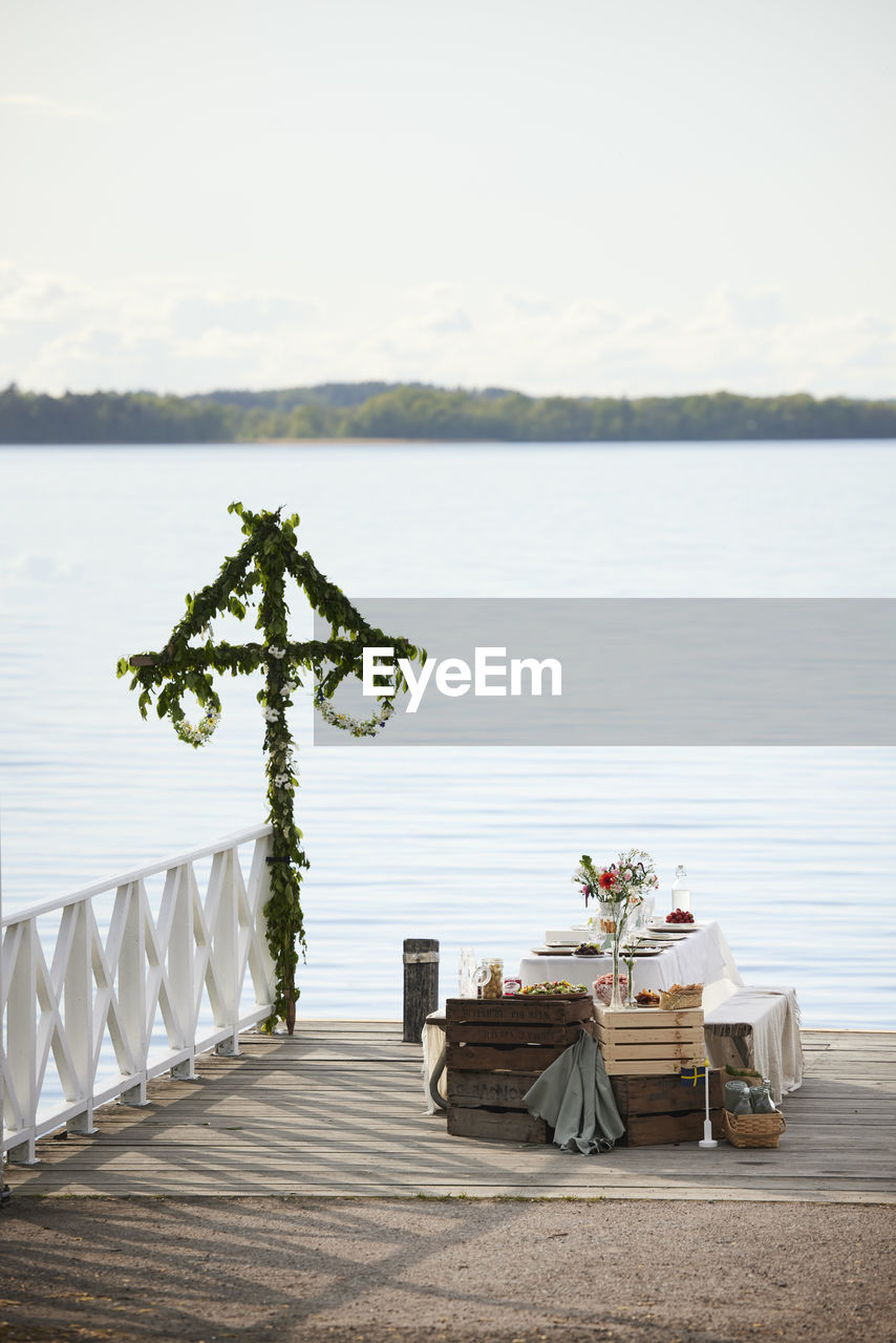 Table with midsummer meal at lake