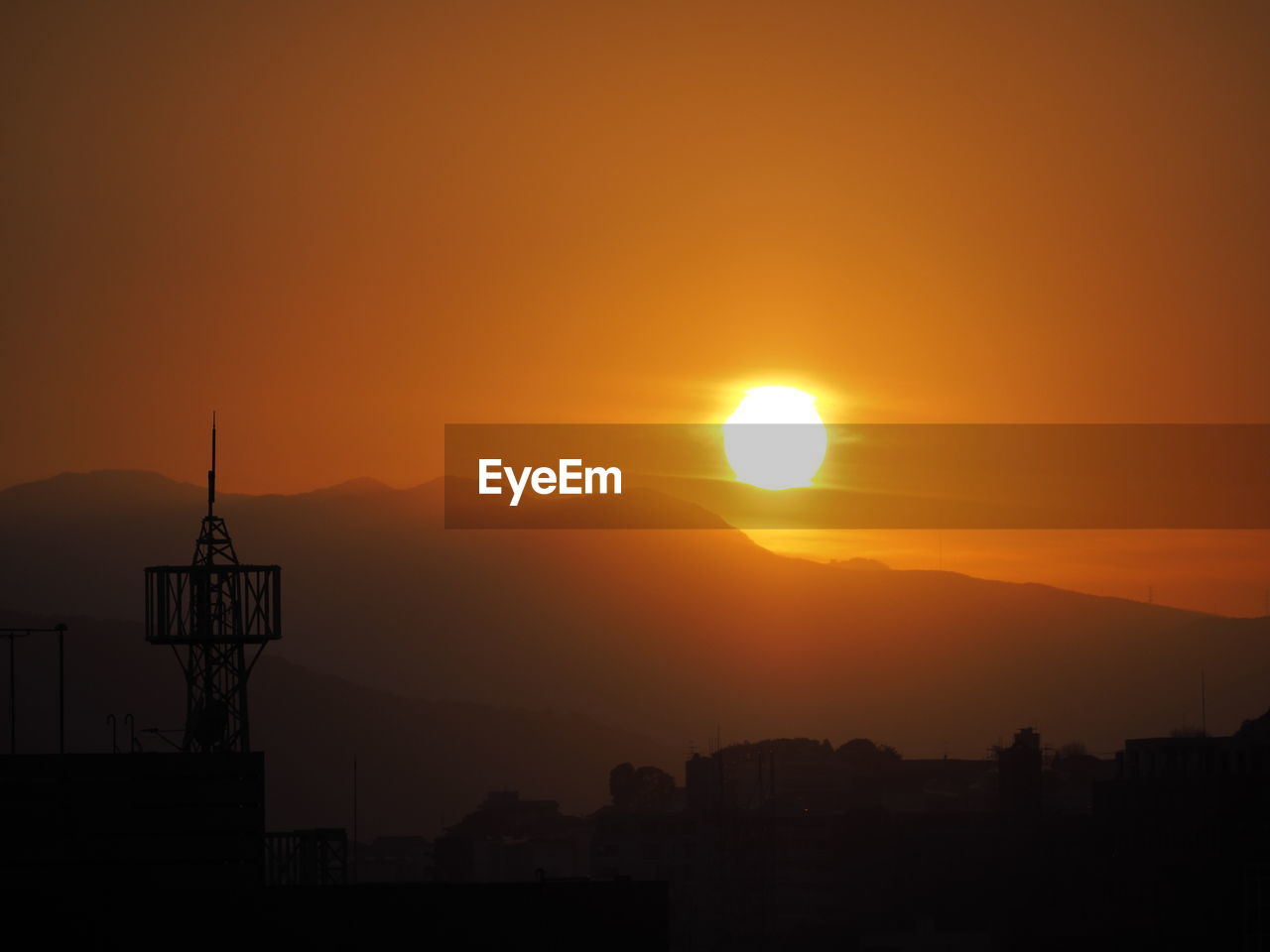 Silhouette buildings against sky during sunset