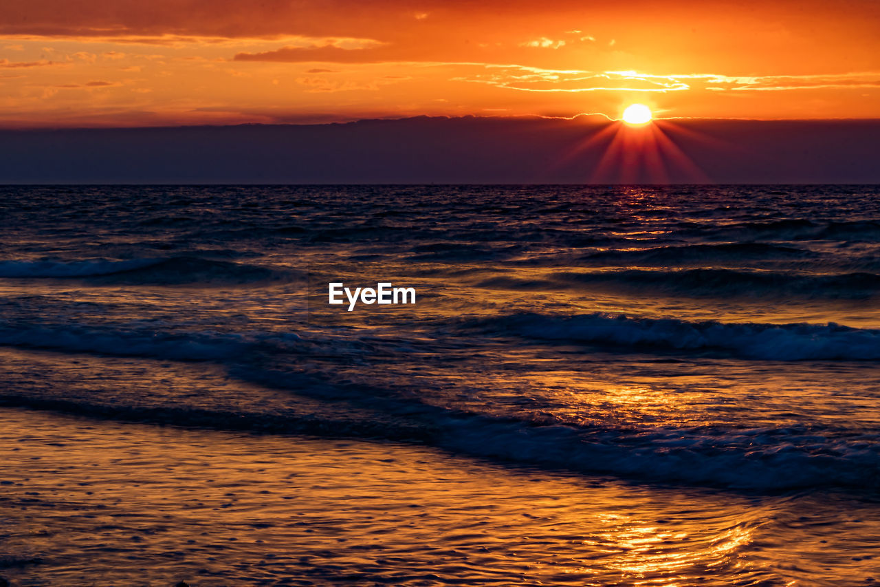 Scenic view of sea against sky during sunset