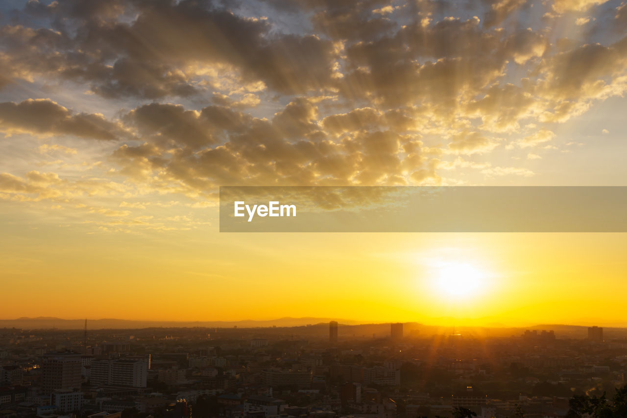 AERIAL VIEW OF CITY AGAINST ROMANTIC SKY AT SUNSET