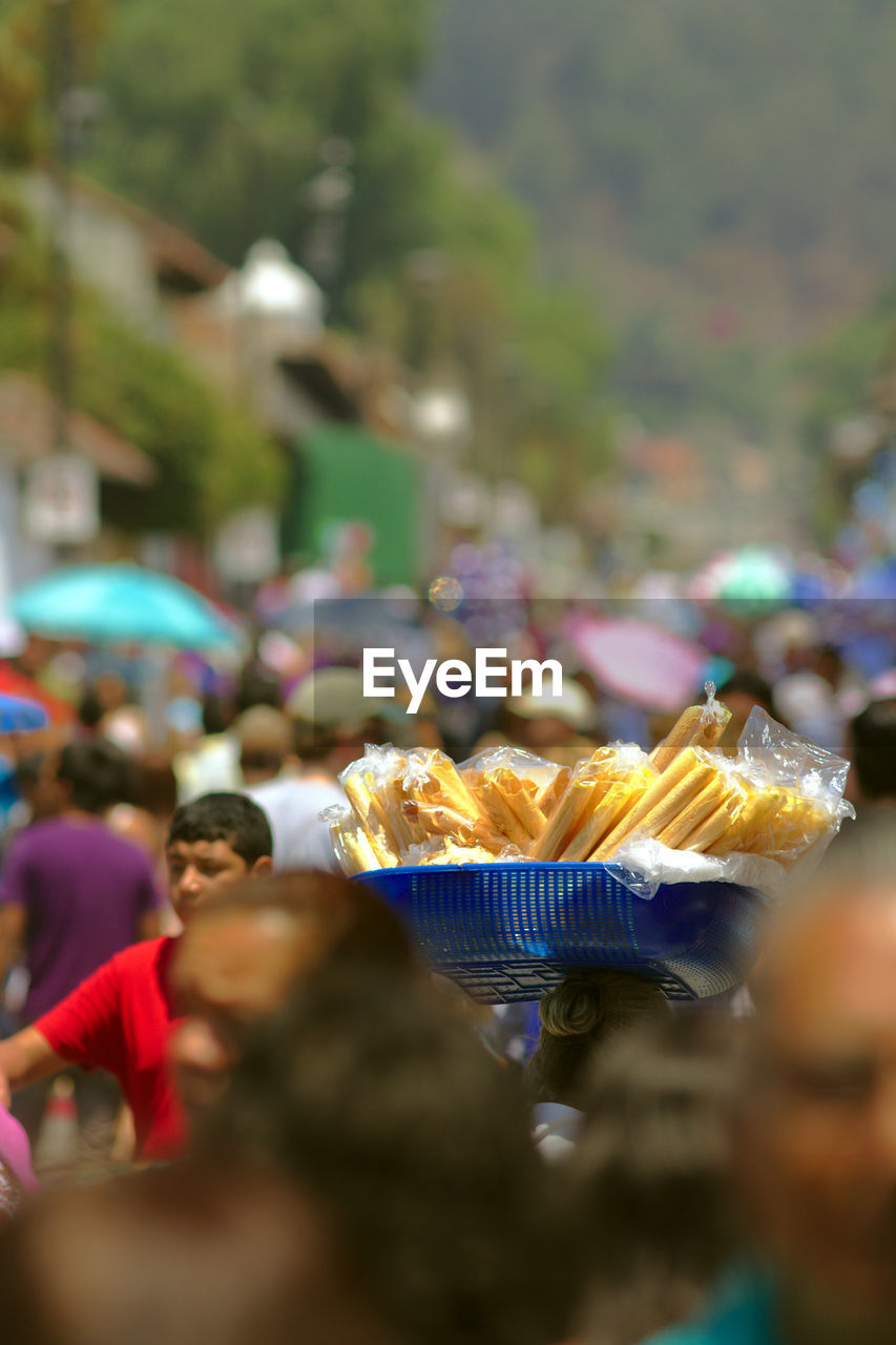 CLOSE-UP OF CROWD IN MARKET