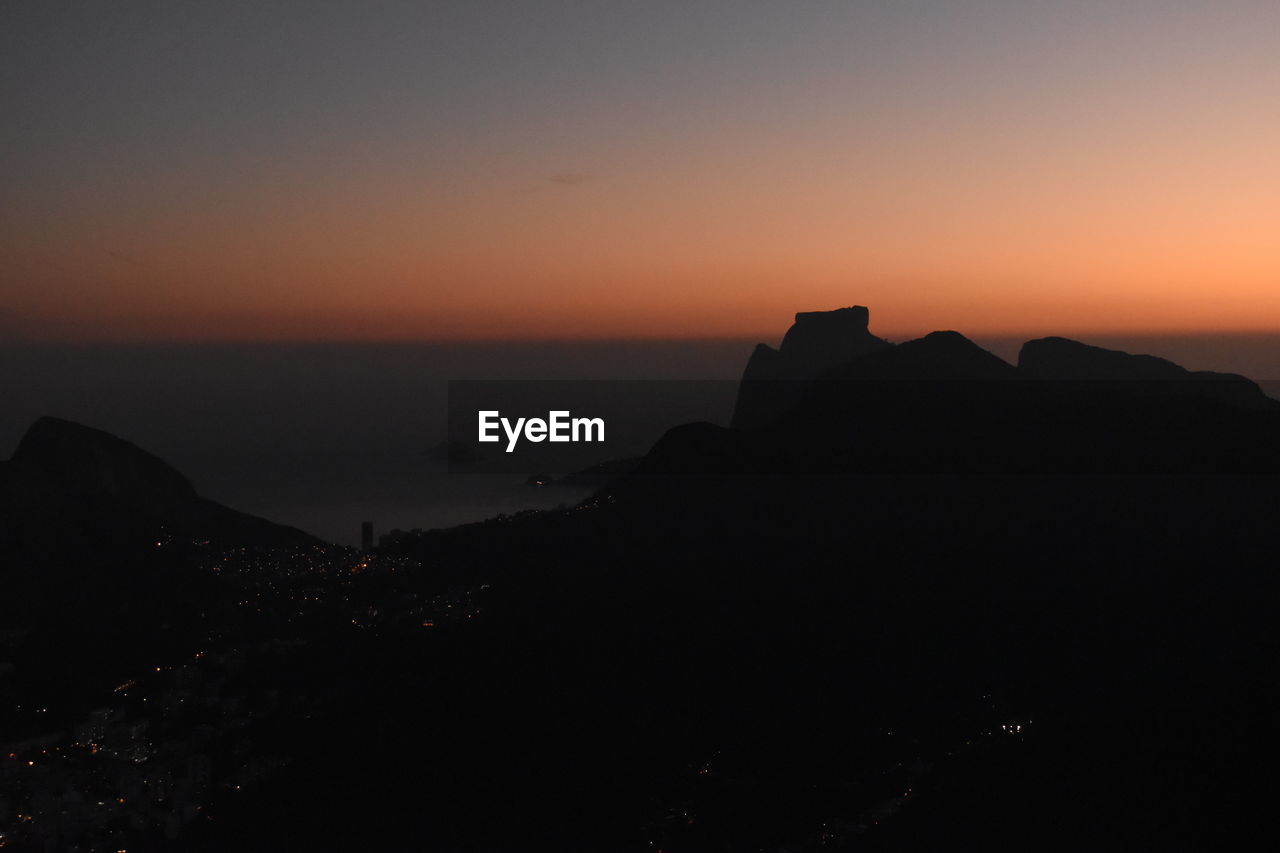 SILHOUETTE MOUNTAIN AGAINST SKY DURING SUNSET