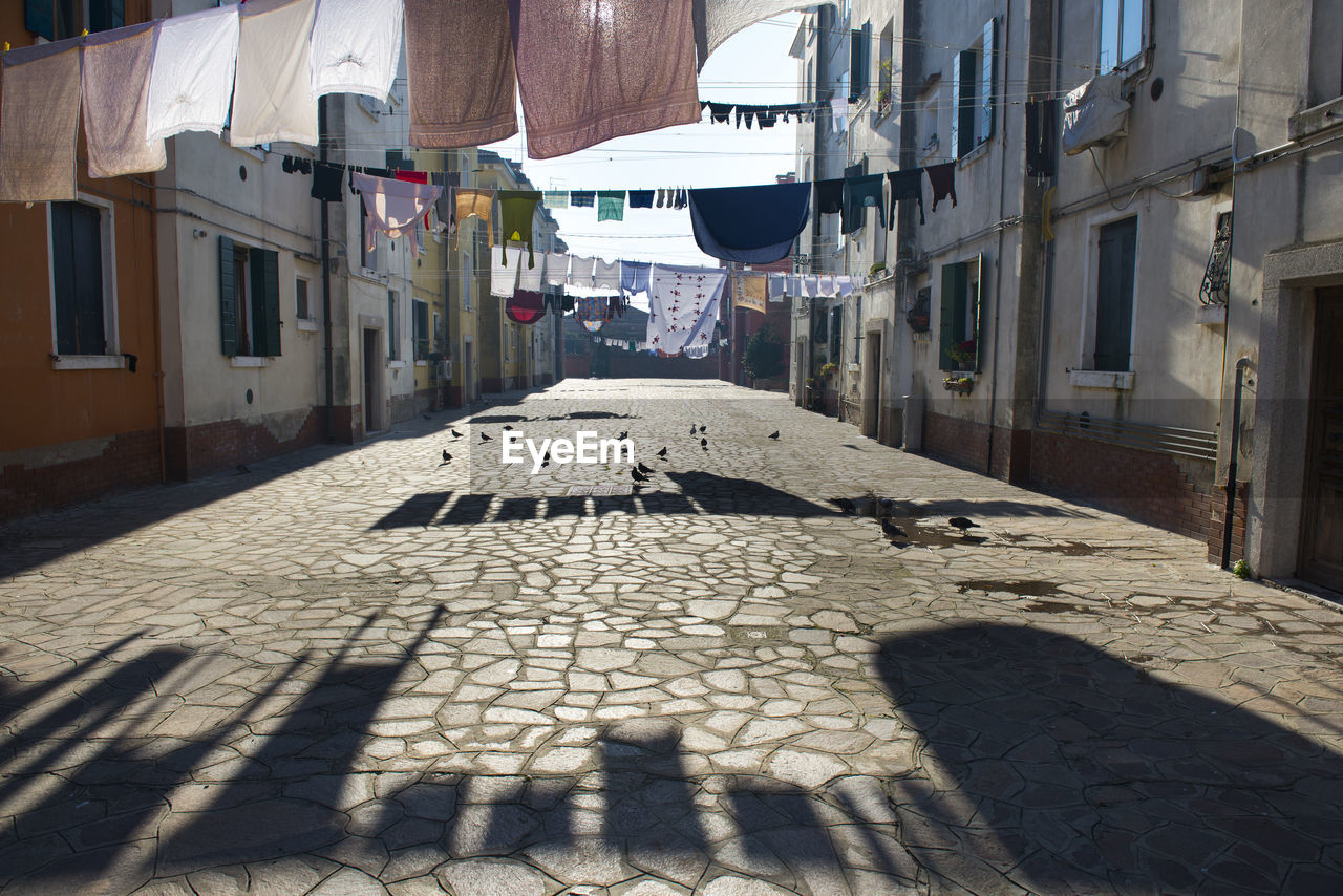 Laundry hanging on clotheslines amidst buildings