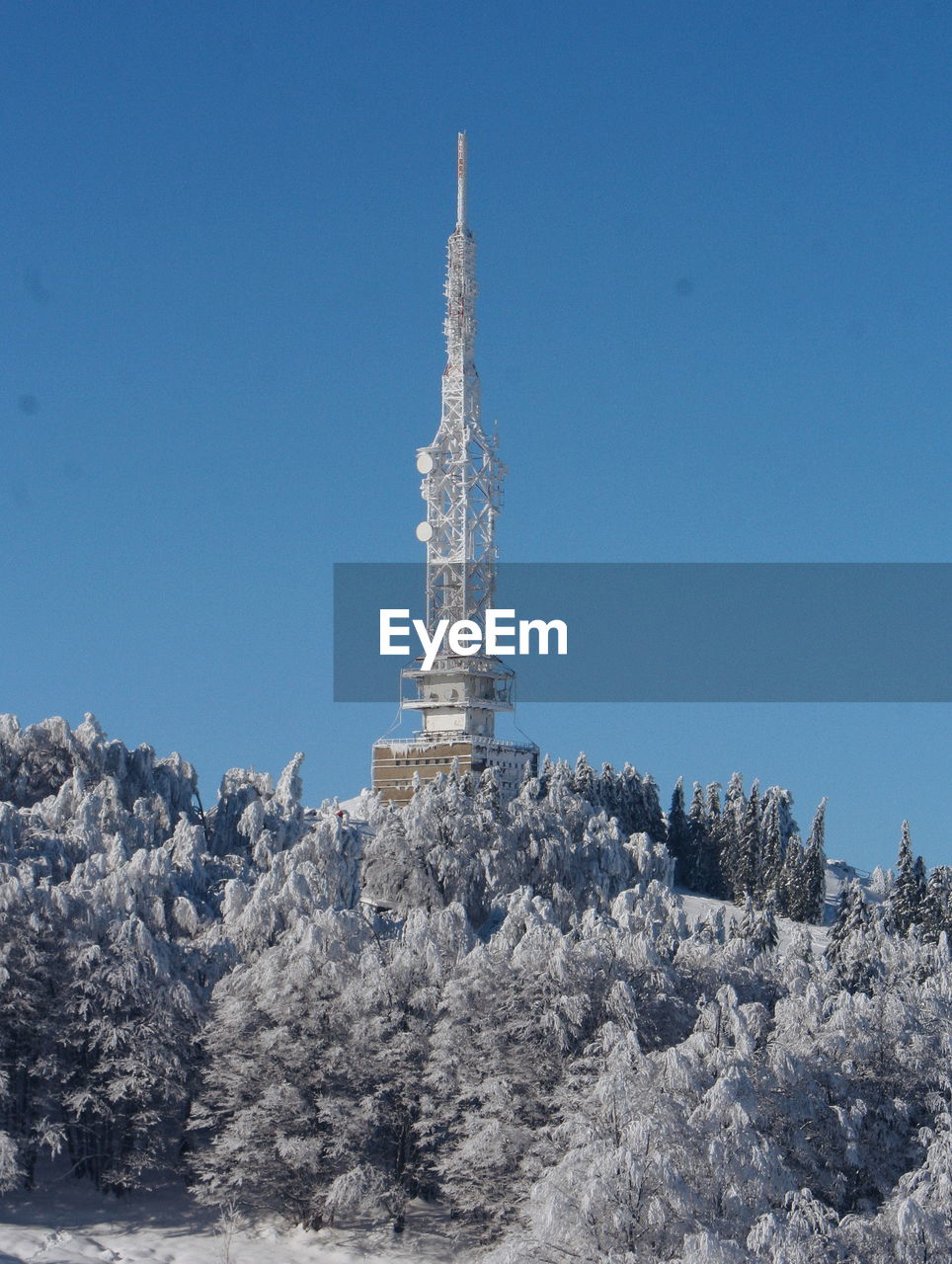 Low angle view of antenna iagainst clear blue sky