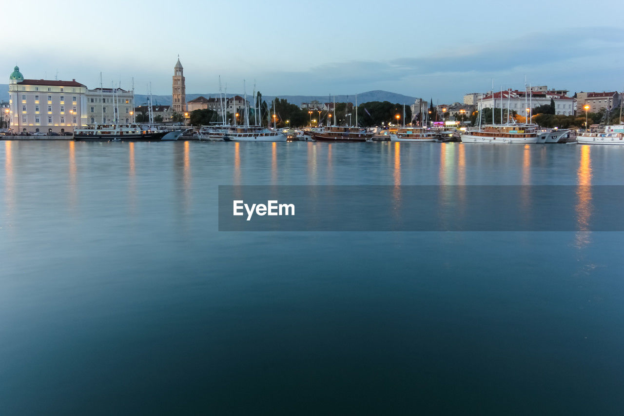 water, architecture, built structure, building exterior, reflection, city, sky, sea, building, travel destinations, harbor, nature, waterfront, no people, bay, horizon, dusk, nautical vessel, cityscape, travel, transportation, tourism, vehicle, outdoors, skyline, marina, ship, dock, day, coast, cloud, blue, residential district, copy space