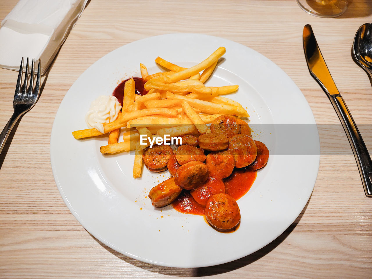food and drink, food, fork, plate, table, eating utensil, kitchen utensil, dish, raw potato, fast food, freshness, meal, silverware, fried, french fries, produce, unhealthy eating, meat, tableware, indoors, household equipment, high angle view, cuisine, wood, knife, table knife, restaurant, no people, serving size, still life, breakfast, business, vegetable, dinner