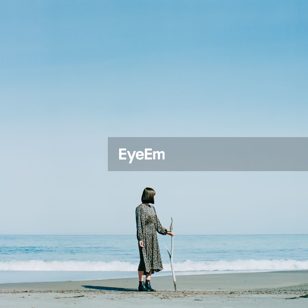 Woman at beach against sky