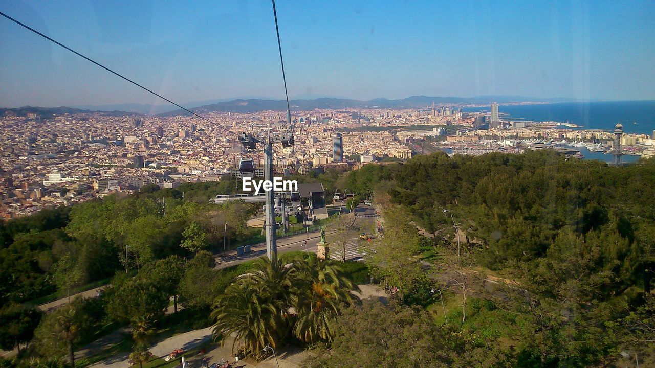 SCENIC VIEW OF SEA AND CITYSCAPE AGAINST SKY