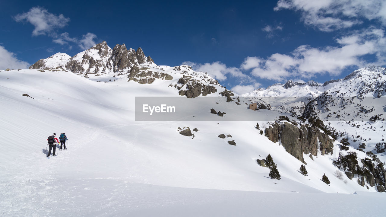 People walking on snow covered mountain